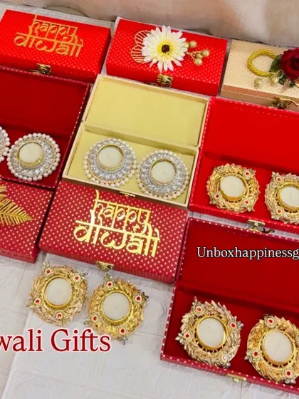 I offer a wide range of decorative diya gift sets, perfect as standalone gifts or as return favors for Diwali parties. This image shows multiple designs in festive red boxes.