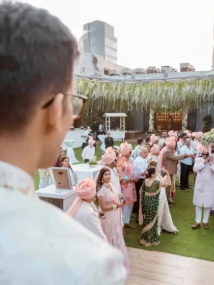 The groom's point of view as he sees his bride making her grand entrance with her family. A powerful storytelling shot.