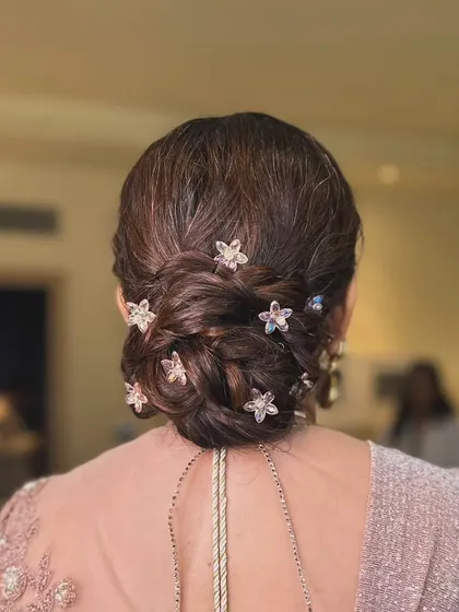 A detailed shot of the elegant braided bun I created for the mother of the bride, adorned with star-shaped accessories.