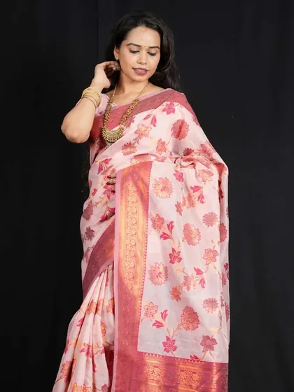 This model wears a long, antique-finish necklace that complements the traditional print and rich border of her cotton saree.