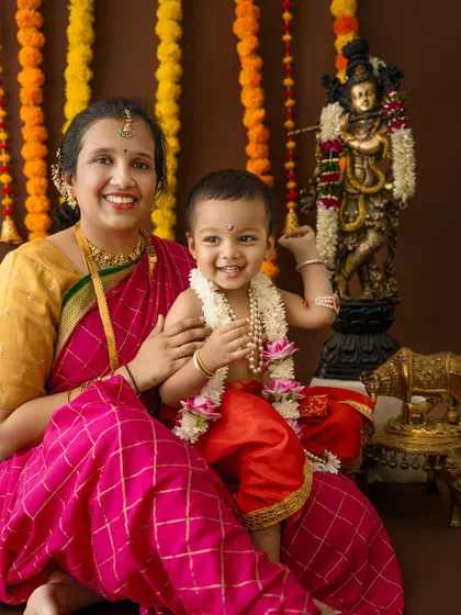 A playful moment with the little Krishna reaching for the sacred lamp.