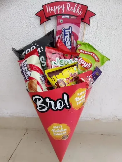 A fun and unique take on a Rakhi gift, this snack bouquet is arranged in a bright red cone. It's overflowing with chips, biscuits, and chocolates, making it a kid-friendly hamper that's easy to gift and exciting to receive.