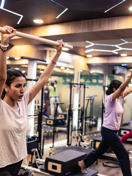 This group exercise uses the wooden dowel to ensure proper shoulder alignment and engagement during a lunge variation. It's an example of how we use simple props to enhance form.