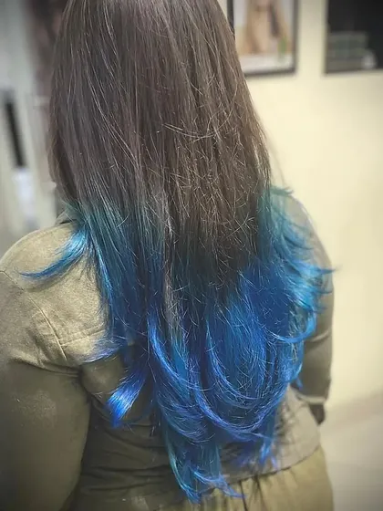 A back view of this stunning blue ombre. The transition from natural dark hair to the vibrant blue is seamless, showcasing our blending technique.
