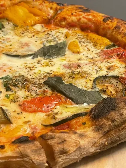 An experimental Burrata pizza with roasted vegetables. I love playing with new flavor combinations to create unique pies for my clients.
