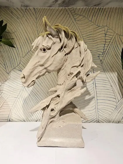 Make a statement with this exquisite stone-finished horse sculpture. This piece of resin art adds a touch of sophistication and power to your living room or office decor.
