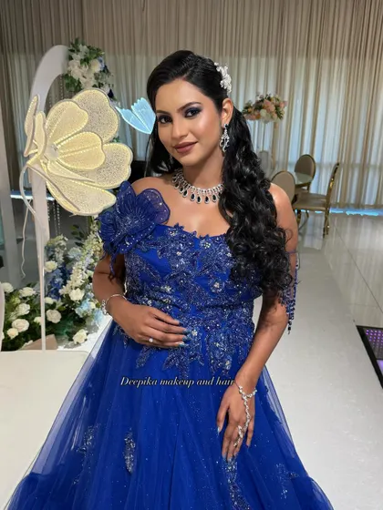 A beautiful client ready for her baby shower party in a stunning blue gown, with makeup that makes her glow.