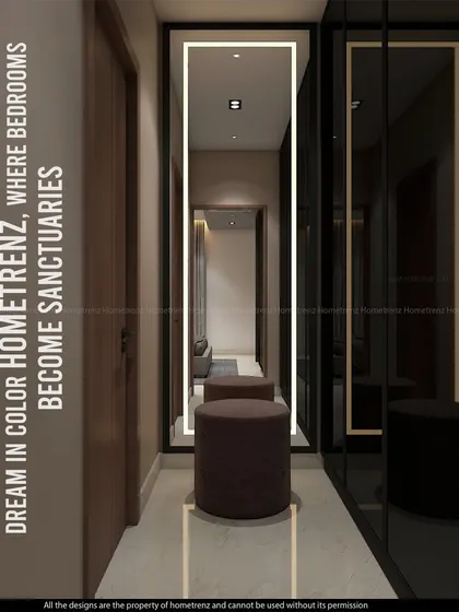 This image shows a dressing area with a full-length back-lit mirror and a dark-tinted glass wardrobe, creating a stylish and functional space to get ready.