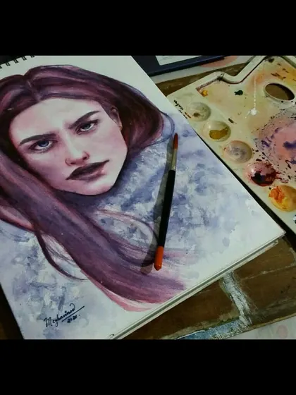 A watercolor portrait with a wintery feel, using shades of purple and grey to create a cool, moody atmosphere. The intense gaze and dark lips add to the dramatic effect.