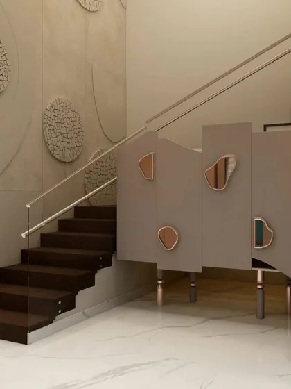 A view of the staircase and foyer, showing the harmonious mix of textures, from smooth glass railings to rough stone art and vertical wall paneling.