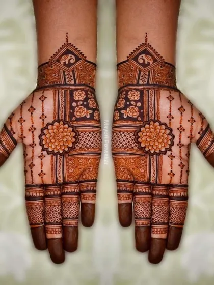 A symmetrical design with a central floral mandala on the palm, complemented by geometric patterns and elephant motifs on the wrist.