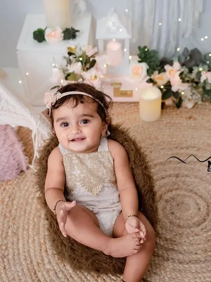 A sweet and simple boho-themed setup for a sitter session. The jute rug, teepee, and soft lighting create a warm and inviting atmosphere.