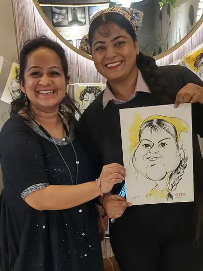 Posing with a happy Costa staff member and her caricature. It's always great to share the fun with the team.