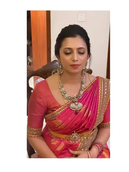 Divya, looking regal in a Sabyasachi saree. The makeup is sophisticated and elegant, designed to complement the designer outfit.
