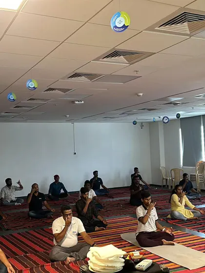 A large group of Autoliv employees practicing pranayama together. It was an honor to lead two back-to-back sessions for such an engaged crowd.