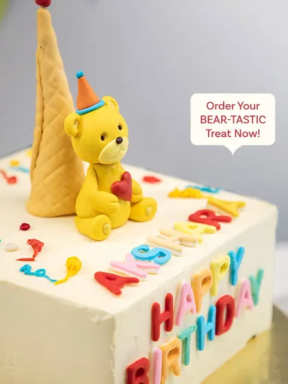 Another angle of the colorful and happy birthday bear cake.