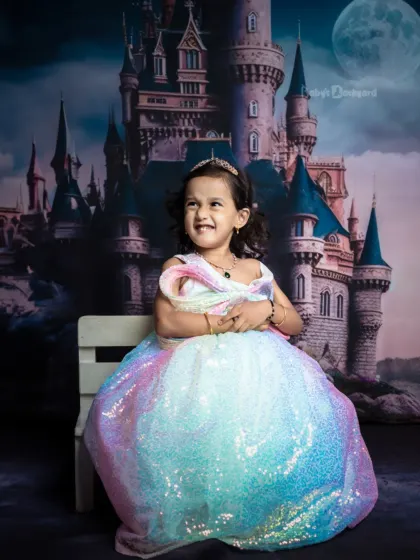 Sparkles, giggles, meet the queen of cuteness. Her expression is priceless in this fairytale setting.