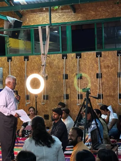 A wide shot of the audience and speaker during a Yoga Vichara event, capturing the community atmosphere.