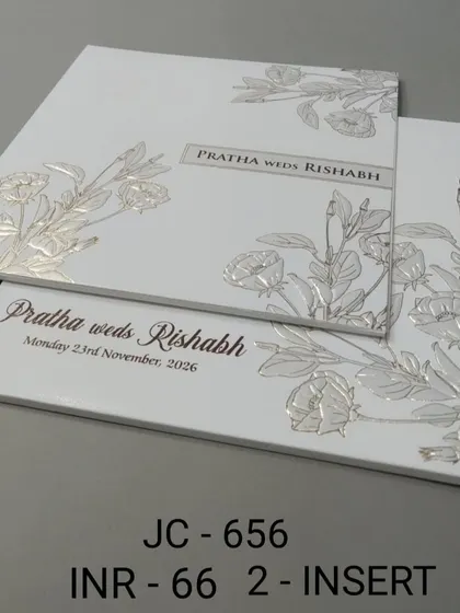 This minimalist white card features silver foil embossed flowers for a subtle, textured look. It's an affordable and stylish option for a modern wedding.