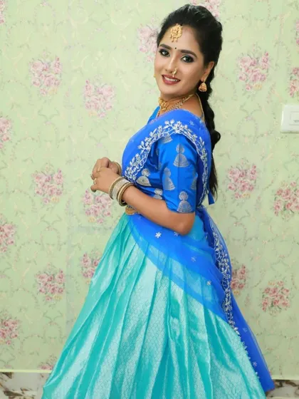 A side view of the blue and aqua half saree, highlighting the silver embroidery on the blue dupatta.