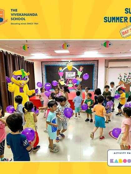 A room full of happy children and purple balloons! Our mascot leads the fun during a summer camp visit, creating a lively and playful atmosphere for everyone.