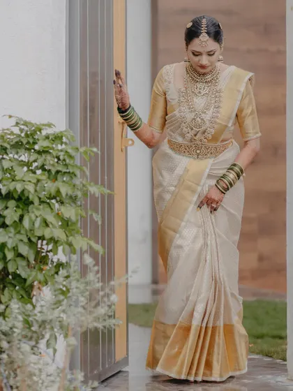 The bride standing gracefully, her traditional attire and elegant pose creating a timeless image.