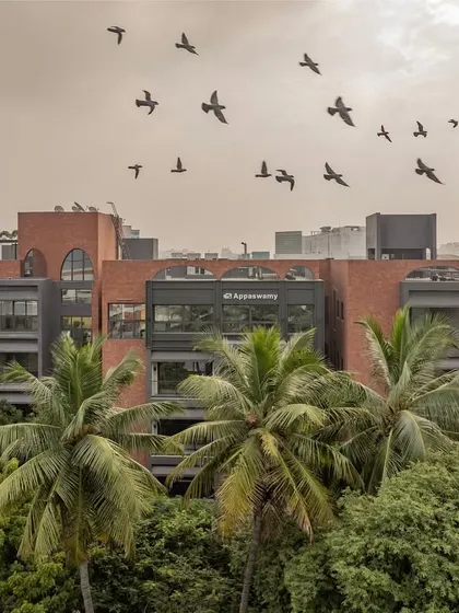 Our ARCUS residential project in Chennai is nestled within a dense urban neighborhood surrounded by trees. This image captures how the building coexists with its green surroundings, a result of our careful planning to preserve the existing foliage and integrate the structure with nature.