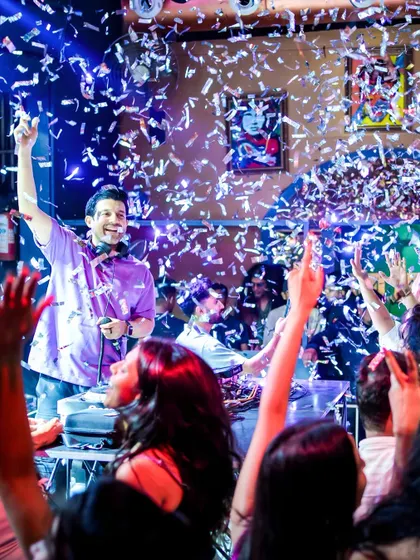 The crowd's energy is everything. Here I am, feeding off the vibe during a packed ladies' night at Happy Brew, with confetti raining down.