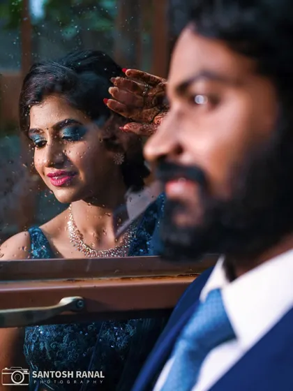 A creative shot using reflection and perspective to capture a tender moment between the couple.
