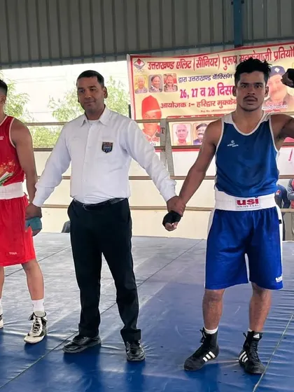 The referee raises our boxer's arm, declaring him the winner. This is the moment every boxer trains for.