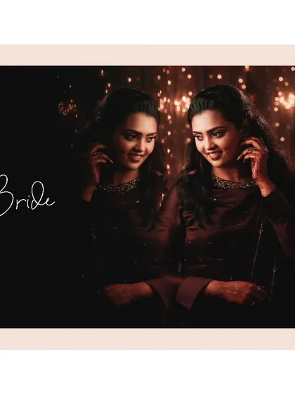 A beautiful reflection portrait of the bride, her smile captured against a backdrop of warm, twinkling lights.