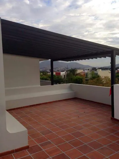 Even a simple structure can make a big impact. We installed this minimalist slatted roof pergola on a terrace to provide shade and define the space, leaving it open and airy.