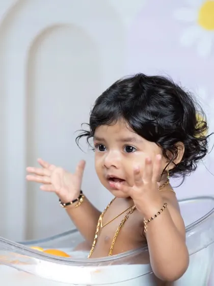 This little girl is having so much fun splashing in her bath.