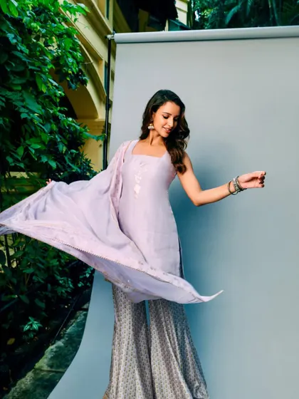 A playful moment captured during the shoot. The lilac color is so soft and pretty, and the outfit moves beautifully.