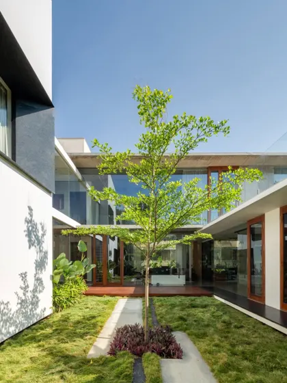 At the heart of the Long House lies this tranquil courtyard, a green lung that organizes the home's spatial flow. This design feature is central to our tropical modern style, allowing for natural ventilation and a constant visual connection to nature from every part of the house.