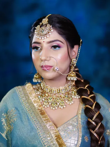 A close-up of the intricate details, from the braided hair with gold accents to the perfectly blended eyeshadow. We focus on teaching the fine details that elevate a look.