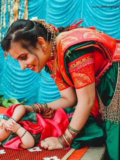 This beautiful moment between a mother and her baby, both in traditional attire, is rich in color and emotion. We specialize in capturing these connections during family functions and ceremonies.