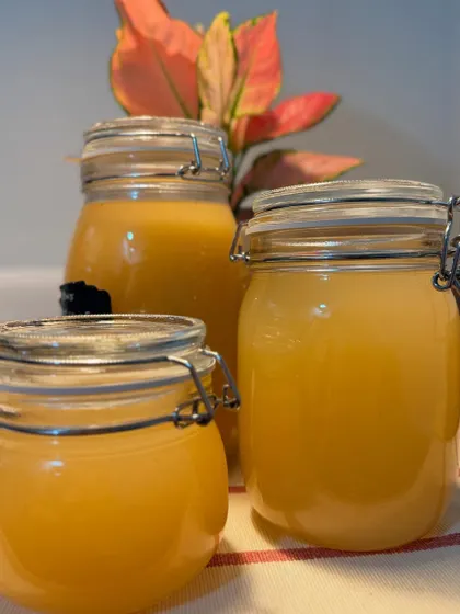 Three jars of our golden-hued ferments, ready to be served. These drinks are a healthy and delicious alternative to commercial beverages, made with care in our own kitchen.