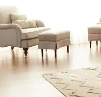 The seating area in the Goa villa, featuring custom armchairs and ottomans with classic turned legs and soft, neutral upholstery. The design is timeless and comfortable.