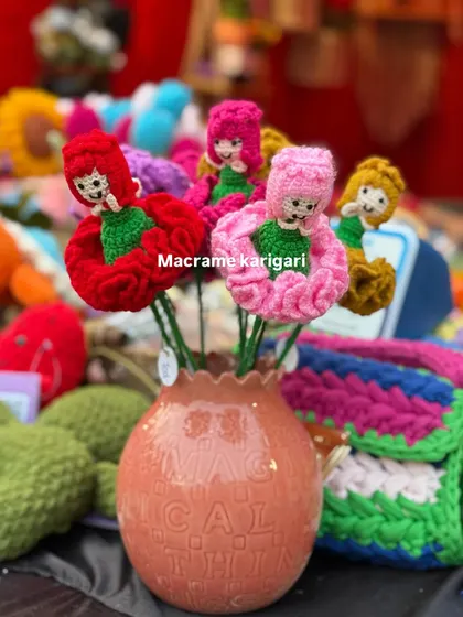 A bouquet of our carnation dolls in a vase. These are a truly unique and imaginative gift, combining the beauty of a flower with the charm of a doll. We make them in various colors.