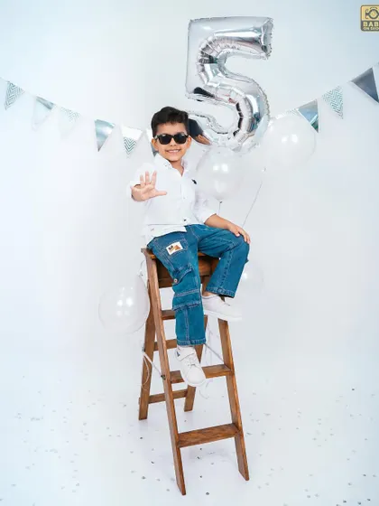 A fun, high-angle shot of the birthday boy looking cool and confident on his fifth birthday.