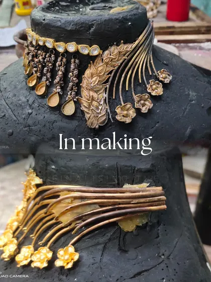 A look at the 'in making' stage of a statement necklace. This shows the raw assembly of the gold components on a bust before the final polishing and stone setting.