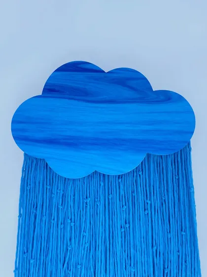 A closer look at the exquisite craftsmanship of our cloud tapestry. The vibrant blue wood features a unique, marbled finish, while the premium cotton threads below are meticulously arranged to create a sense of texture and flow, highlighting the quality of our materials.