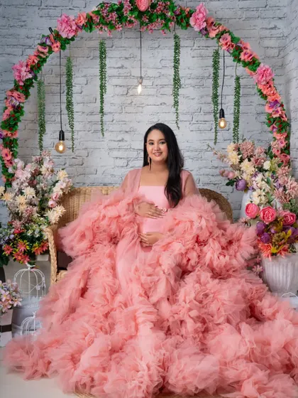 Another beautiful seated portrait in the pink gown, showcasing the versatility of our floral arch set.