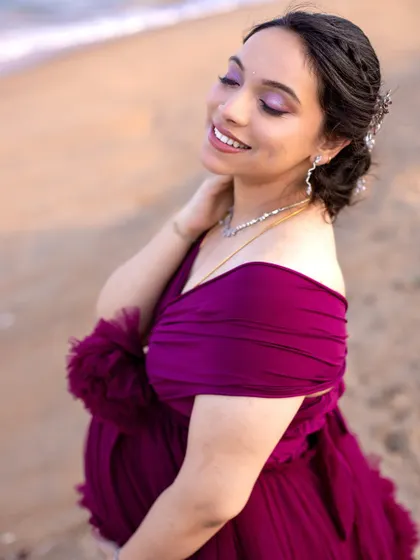 A beautiful close-up portrait, highlighting the mom-to-be's radiant smile and elegant makeup and hair.