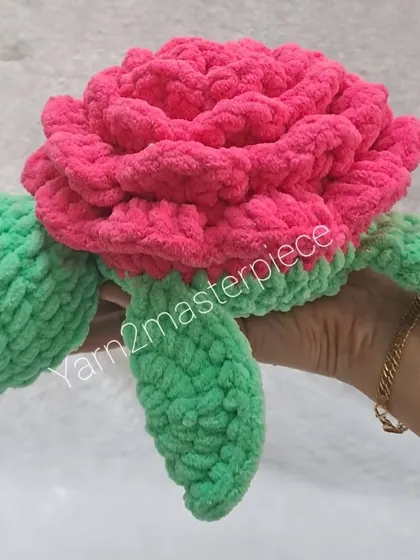 Holding one of the 10-inch rose turtles to show its substantial size. It's a big, huggable toy that's sure to be loved.