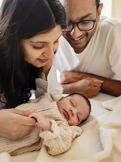 New parents lost in the moment with their sleeping baby. These overhead shots create a beautiful, intimate perspective of your new family.