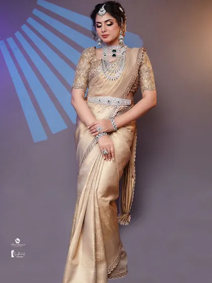 A full-length shot demonstrating the complete look, including the draping of the silk saree and the diamond waist belt.
