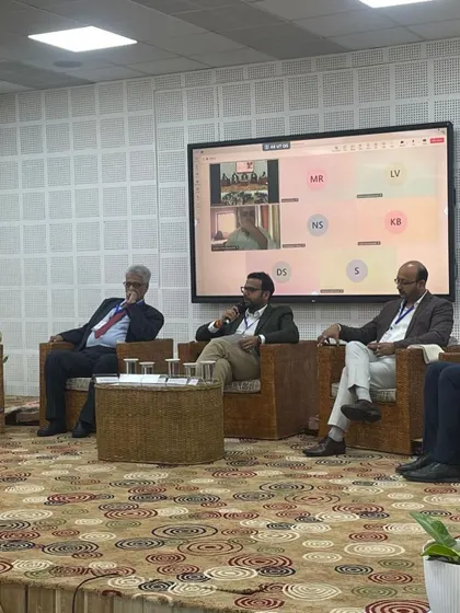 Saurabh Bindal moderating the panel discussion on technology transfer, which included virtual participants, showcasing a hybrid event format.