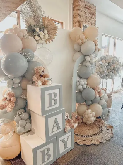 A "Peach and Grey" baby shower theme. This setup uses a soft, modern color palette with teddy bears and "BABY" blocks for a cute and contemporary look.